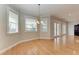 Bright dining room with wood floors, chandelier, large windows, and views of the outside at 1825 Bayshore Dr, Terra Ceia, FL 34250