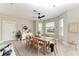 Bright dining room featuring a modern table set, a ceiling fan, and large windows at 1825 Bayshore Dr, Terra Ceia, FL 34250