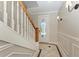 Inviting entryway with decorative tile flooring, a staircase, and a door with decorative glass at 1825 Bayshore Dr, Terra Ceia, FL 34250