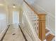Elegant foyer with decorative tile flooring, a staircase with wood banister, and detailed trim work at 1825 Bayshore Dr, Terra Ceia, FL 34250