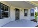 Welcoming front porch with stylish windows, a secure screen door, and a freshly painted floor at 1825 Bayshore Dr, Terra Ceia, FL 34250
