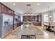 Spacious kitchen with dark wood cabinets, stainless steel appliances, and a large center island at 1825 Bayshore Dr, Terra Ceia, FL 34250