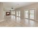 Spacious living room featuring neutral walls, tile flooring, ceiling fans, and double doors to the porch at 1825 Bayshore Dr, Terra Ceia, FL 34250