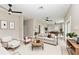 Open-concept living area with neutral walls, tile floors, modern furniture, and seamless flow to dining room at 1825 Bayshore Dr, Terra Ceia, FL 34250