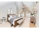 Beautifully staged main bedroom with vaulted ceiling, hardwood floors and sophisticated decor at 1825 Bayshore Dr, Terra Ceia, FL 34250