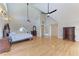 Large bedroom boasts hardwood floors, vaulted ceilings, ceiling fans and a decorative dresser at 1825 Bayshore Dr, Terra Ceia, FL 34250