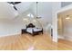 Spacious main bedroom featuring hardwood floors, a vaulted ceiling, and a ceiling fan at 1825 Bayshore Dr, Terra Ceia, FL 34250