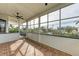 Relaxing screened-in patio with brick floors, ceiling fan, and views of the tropical landscape at 1825 Bayshore Dr, Terra Ceia, FL 34250