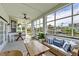 Covered patio showcasing waterfront views, comfortable seating, and a hanging swing chair at 1825 Bayshore Dr, Terra Ceia, FL 34250