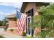 A welcoming entrance with an American flag flying high and a decorative screen door adds charm to the property at 2720 S Biscayne Dr, North Port, FL 34287