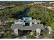 Aerial view of building and pool on the water surrounded by trees at 304 Pine Run Dr, Osprey, FL 34229