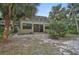 Inviting backyard featuring lush greenery, mature trees, and patio, offering a peaceful outdoor retreat at 304 Pine Run Dr, Osprey, FL 34229