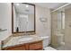 Bathroom featuring a granite countertop, wood cabinets, and a glass-enclosed shower at 304 Pine Run Dr, Osprey, FL 34229