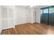 Bedroom with hardwood floors, neutral walls, ceiling fan and access to a screened lanai at 304 Pine Run Dr, Osprey, FL 34229