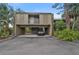 Multi-level condo building with covered parking and lush landscaping, offering privacy and convenience at 304 Pine Run Dr, Osprey, FL 34229
