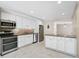 Bright kitchen with white cabinets, stainless steel appliances, and granite countertops at 304 Pine Run Dr, Osprey, FL 34229
