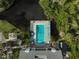 Aerial view of a beautiful pool surrounded by chairs on the water at 304 Pine Run Dr, Osprey, FL 34229