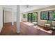 Spacious sun room featuring wood-look floors, several windows, and natural light at 304 Pine Run Dr, Osprey, FL 34229