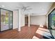 Bright sun room with wood-look flooring, multiple ceiling fans, and abundant natural light at 304 Pine Run Dr, Osprey, FL 34229