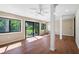 Bright sun room featuring wood-look flooring, several windows, and natural light at 304 Pine Run Dr, Osprey, FL 34229
