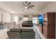 Cozy living room with neutral tones, large windows, tile flooring, and comfortable seating arrangement at 3164 Lotus Rd, North Port, FL 34291