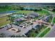 Aerial view of community amenities including pools, clubhouse, parking, and green spaces at 4326 Silo Port Ct, Lakewood Ranch, FL 34211