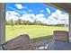 Relaxing view of the expansive backyard from the covered patio seating area at 4326 Silo Port Ct, Lakewood Ranch, FL 34211