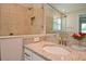 Bathroom with a glass enclosed shower and granite countertop with white cabinets at 4326 Silo Port Ct, Lakewood Ranch, FL 34211