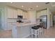 A modern kitchen featuring white cabinets, stainless steel appliances, a large island, and tiled flooring at 4326 Silo Port Ct, Lakewood Ranch, FL 34211