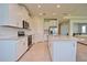 A well-lit kitchen with white cabinets, stainless steel appliances, granite countertops and tile flooring at 4326 Silo Port Ct, Lakewood Ranch, FL 34211