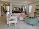 Open-concept living room with large sectional sofa and abundant natural light at 4326 Silo Port Ct, Lakewood Ranch, FL 34211