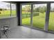 Bright sunroom featuring tile flooring, glass windows and doors with beautiful backyard views at 4326 Silo Port Ct, Lakewood Ranch, FL 34211