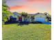 Charming single-story home with a lush green lawn, complemented by tropical landscaping and a two-car garage at 4581 E Dover Street Cir, Bradenton, FL 34203