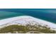 An aerial view of beach showing the white sand beach meeting the blue ocean at 727 Holly Rd, Anna Maria, FL 34216