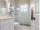Bright bathroom with a walk-in shower, white vanity, and decorative shelving for added appeal at 727 Holly Rd, Anna Maria, FL 34216