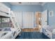 Bedroom with wood flooring, bunk beds, large closet, and a view into the living room at 727 Holly Rd, Anna Maria, FL 34216