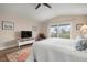 Well-lit bedroom featuring light floors, a ceiling fan, and a sliding glass door to a balcony at 727 Holly Rd, Anna Maria, FL 34216