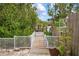 Private wooden dock surrounded by lush green trees at 727 Holly Rd, Anna Maria, FL 34216