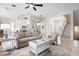 Bright living room, with stylish furnishings, access to the kitchen and stairs leading to the second floor at 727 Holly Rd, Anna Maria, FL 34216