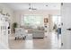 Open living room with tile flooring, ceiling fan, comfortable seating and sliding doors to outdoor patio at 727 Holly Rd, Anna Maria, FL 34216