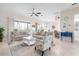 Bright living room, with stylish furnishings, dining area and access to a screened lanai with great views at 727 Holly Rd, Anna Maria, FL 34216