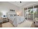 Well lit main bedroom with hardwood flooring, slider doors to patio, and coastal decor at 727 Holly Rd, Anna Maria, FL 34216