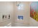 Stairway with an abundance of natural light from the skylight and decorative wall art at 727 Holly Rd, Anna Maria, FL 34216