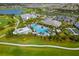 Expansive aerial view of a community with a pool, clubhouse, and meticulously maintained landscaping at 16127 Fortezza Dr, Bradenton, FL 34211
