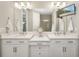 Modern bathroom featuring a double vanity, quartz countertops, TV, and neutral color palette at 16127 Fortezza Dr, Bradenton, FL 34211