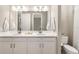 Bright bathroom featuring double vanity, white cabinetry, and a toilet at 16127 Fortezza Dr, Bradenton, FL 34211