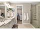 Beautiful primary bathroom with dual sinks, glass shower, and walk-in closet access at 16127 Fortezza Dr, Bradenton, FL 34211