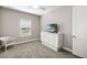 Well-lit bedroom with a window and a white media console; featuring neutral walls and carpet at 16127 Fortezza Dr, Bradenton, FL 34211