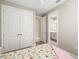 Bright bedroom featuring a floral comforter, a ceiling fan, and an ensuite bathroom at 16127 Fortezza Dr, Bradenton, FL 34211