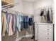 Walk-in closet providing ample storage space with shelving, hanging rods, and a dresser at 16127 Fortezza Dr, Bradenton, FL 34211
